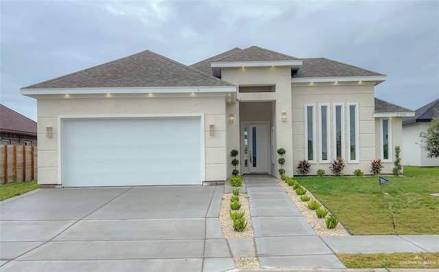 prairie-style home featuring a front yard and a garage