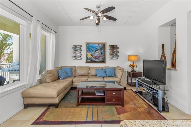 living room featuring ceiling fan and tile patterned flooring