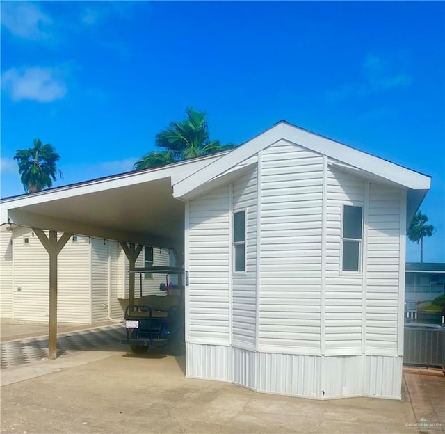 view of side of property featuring a carport