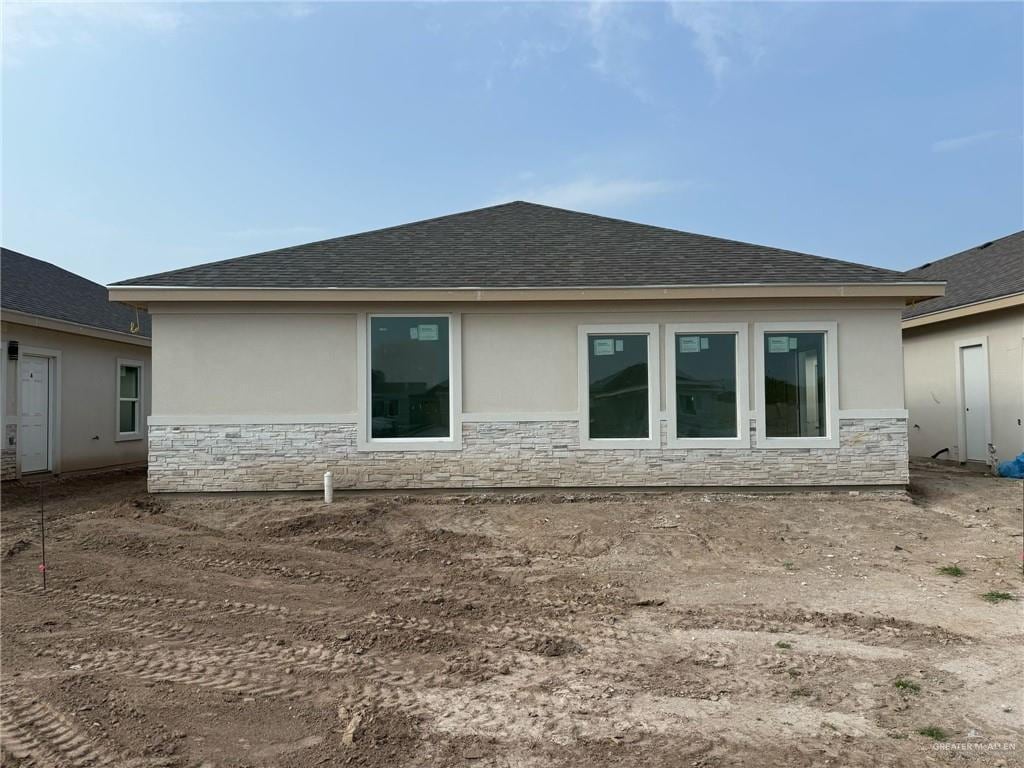 5322 Vision, Rio Grande City, TX 78582 - back of property with a shingled roof, stone siding, and stucco siding