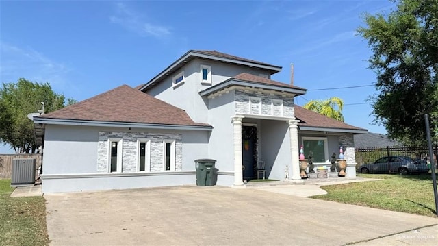 view of front of property with central AC, a patio area, and a front yard