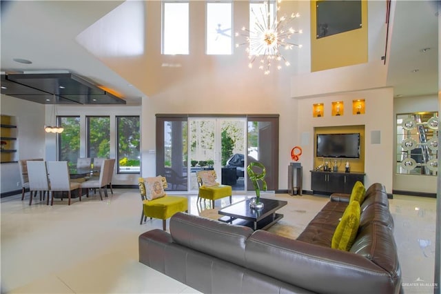 309 N Mockingbird Ave, Mission, TX 78572 - living room with a chandelier, a high ceiling, and healthy amount of natural light