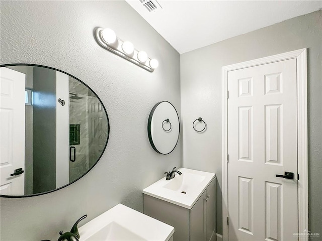 511 W Samano St, Edinburg, TX 78539 - bathroom with two vanities and a shower stall