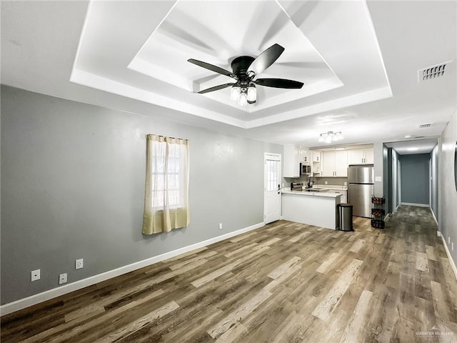 511 W Samano St, Edinburg, TX 78539 - unfurnished living room with a raised ceiling, dark wood finished floors, and a ceiling fan