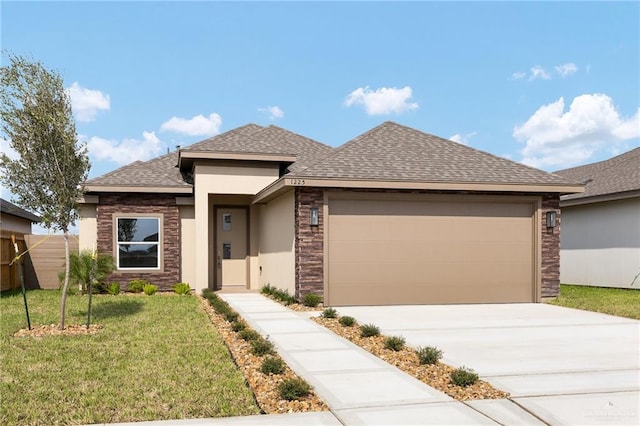 prairie-style house featuring a garage and a front lawn