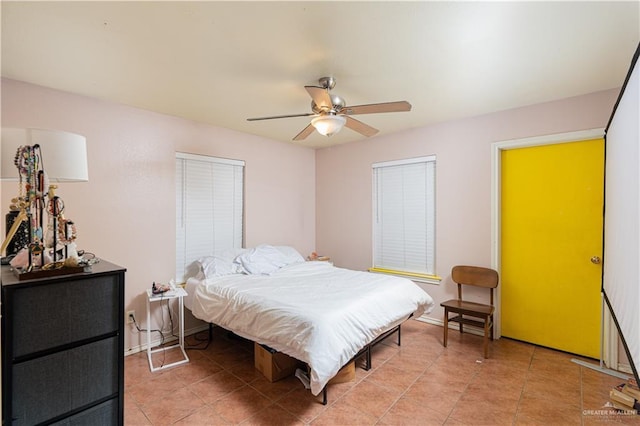 bedroom featuring a ceiling fan, baseboards, and tile patterned floors