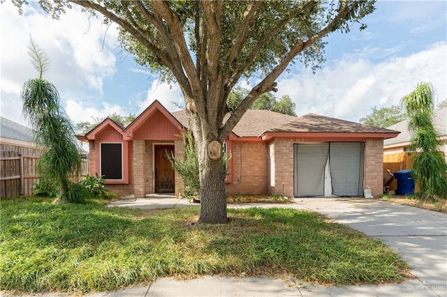 ranch-style home with concrete driveway, an attached garage, fence, a front lawn, and brick siding