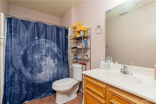 bathroom with vanity, toilet, and tile patterned floors