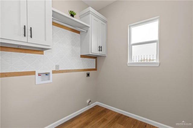 laundry area with cabinets, hookup for a washing machine, light hardwood / wood-style floors, and hookup for an electric dryer