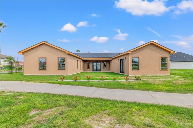 rear view of property with a lawn