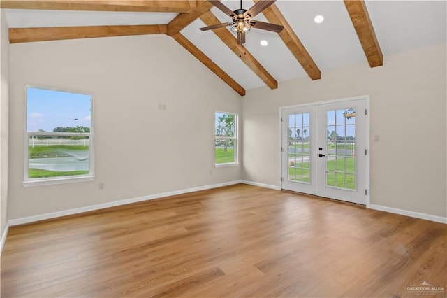 unfurnished living room featuring beamed ceiling, light hardwood / wood-style flooring, and french doors