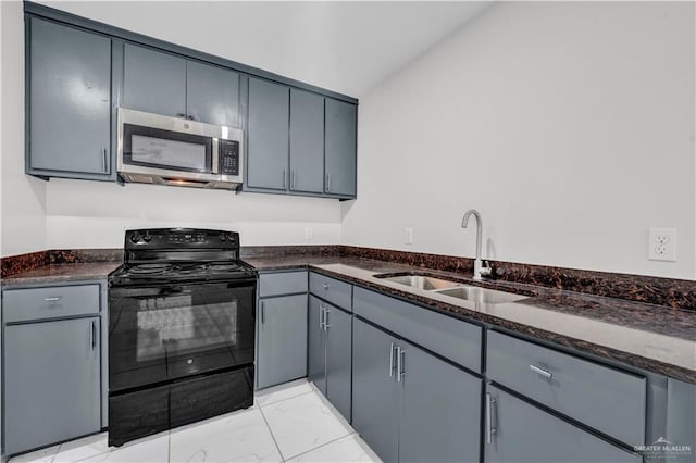 kitchen featuring sink, dark stone countertops, gray cabinetry, electric range, and vaulted ceiling