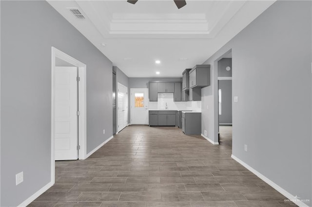 kitchen featuring light countertops, baseboards, visible vents, and gray cabinetry