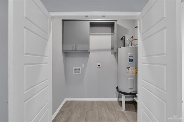 laundry area featuring hookup for a washing machine, cabinet space, light wood-style floors, electric water heater, and hookup for an electric dryer