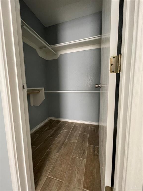 walk in closet with wood tiled floor