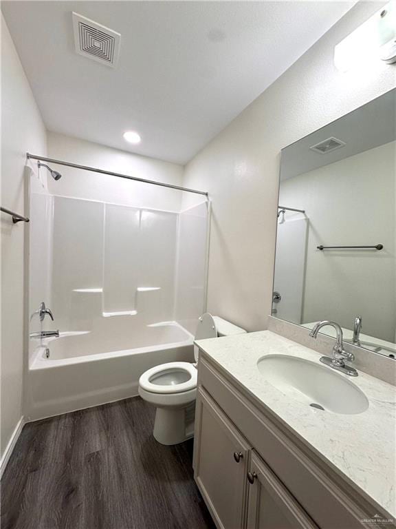 full bathroom with visible vents, vanity, toilet, and wood finished floors