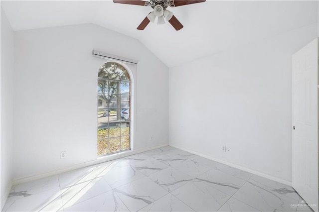 spare room featuring ceiling fan, vaulted ceiling, and a wealth of natural light