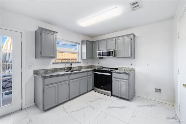 kitchen with range with electric cooktop, gray cabinets, and sink