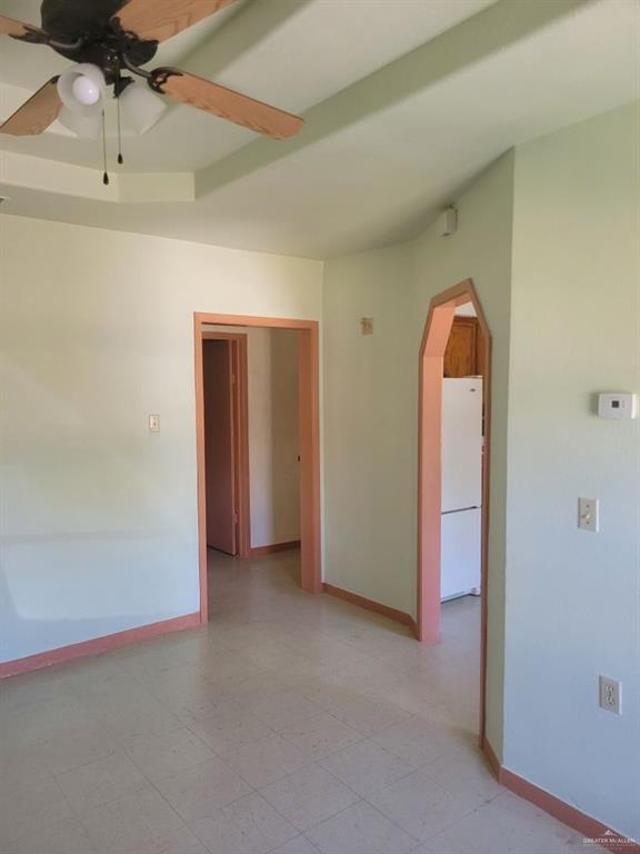 233 W 4th St, La Joya, TX 78560 - spare room with arched walkways, a ceiling fan, and baseboards