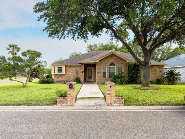 ranch-style house with brick siding and a front yard