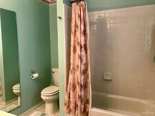 bathroom featuring shower / bath combination with curtain and toilet