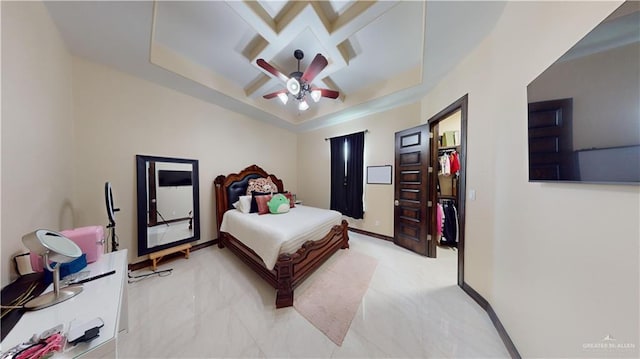 bedroom featuring a tray ceiling and ceiling fan