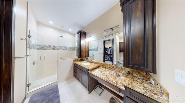 bathroom featuring vanity and a shower with shower door