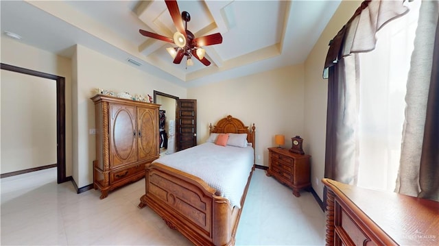 bedroom featuring ceiling fan and a tray ceiling