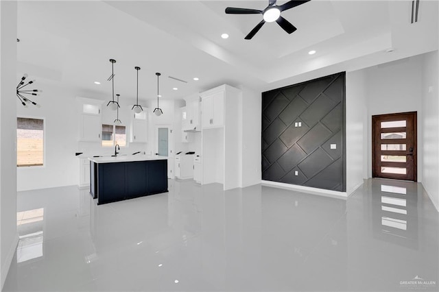 3433 E Kidd Ave, Edinburg, TX 78542 - unfurnished living room with light tile patterned floors, ceiling fan, recessed lighting, a sink, and a raised ceiling