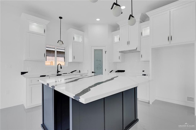 3433 E Kidd Ave, Edinburg, TX 78542 - kitchen with white cabinets, glass insert cabinets, recessed lighting, a kitchen island, and tasteful backsplash