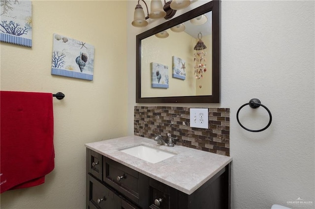 bathroom featuring vanity and decorative backsplash