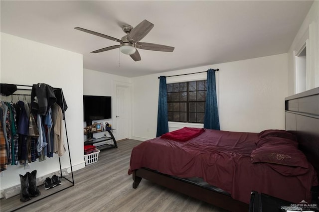 bedroom with hardwood / wood-style floors and ceiling fan