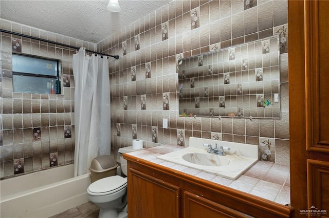 full bathroom featuring shower / tub combo, tile walls, vanity, a textured ceiling, and toilet