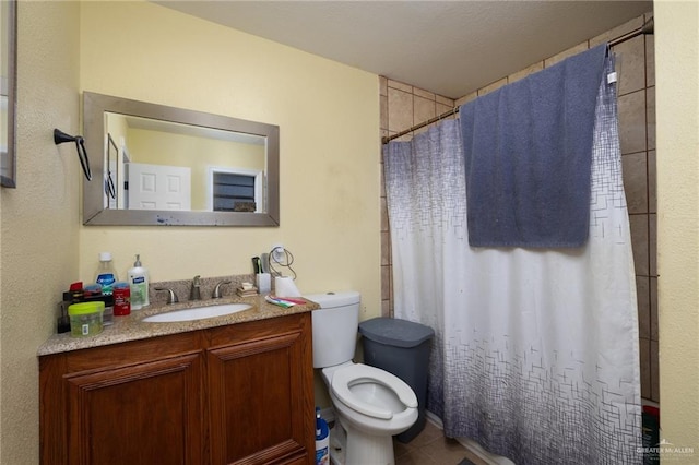 bathroom with tile patterned flooring, vanity, curtained shower, and toilet