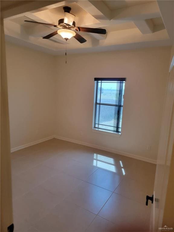 unfurnished room featuring ceiling fan, coffered ceiling, tile patterned floors, a raised ceiling, and beamed ceiling