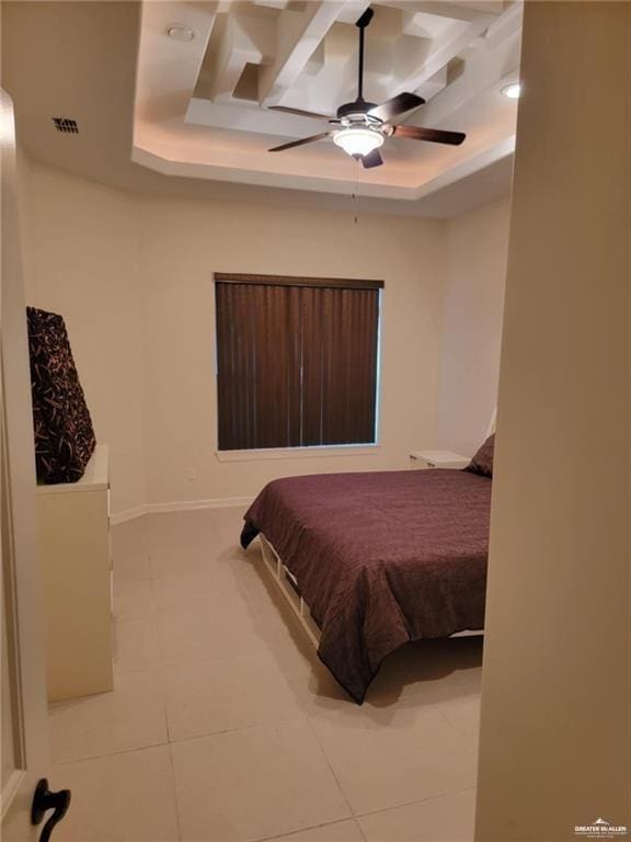 bedroom with ceiling fan and a tray ceiling