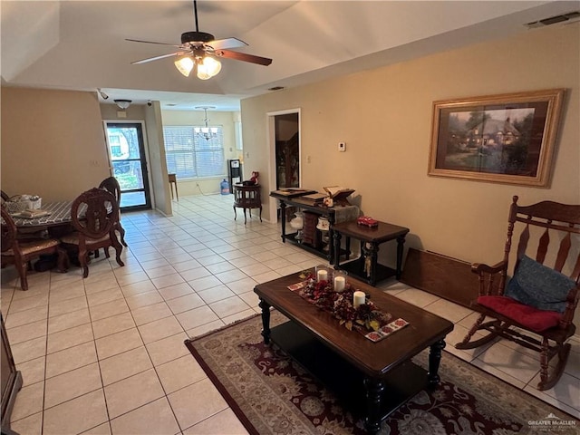 2301 Wisteria Ave, Mission, TX 78574 - living room featuring light tile patterned flooring, ceiling fan, and a chandelier