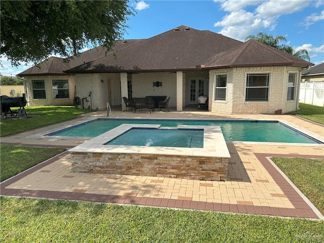 5845 Acacia St, Harlingen, TX 78552 - view of swimming pool featuring an in-ground hot tub, a patio, and french doors