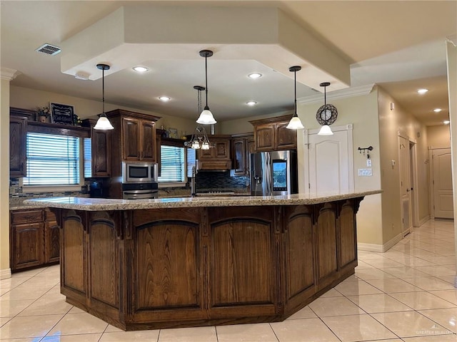 5845 Acacia St, Harlingen, TX 78552 - kitchen with stainless steel appliances, a kitchen breakfast bar, dark brown cabinetry, light tile patterned flooring, and recessed lighting
