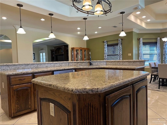 5845 Acacia St, Harlingen, TX 78552 - kitchen featuring light tile patterned floors, arched walkways, a sink, a center island, and recessed lighting