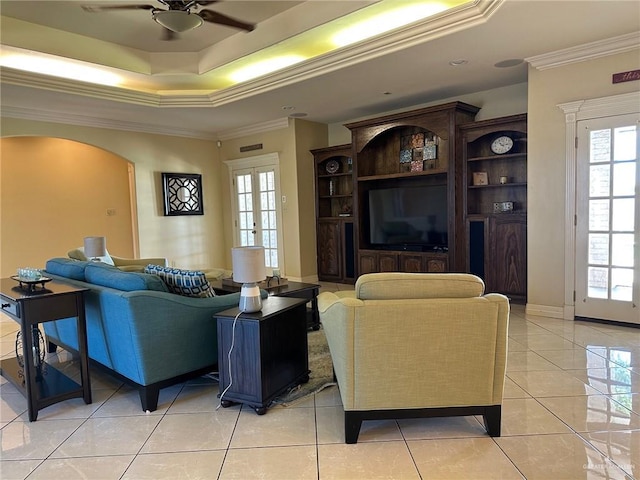 5845 Acacia St, Harlingen, TX 78552 - living area featuring ceiling fan, crown molding, light tile patterned flooring, arched walkways, and a tray ceiling
