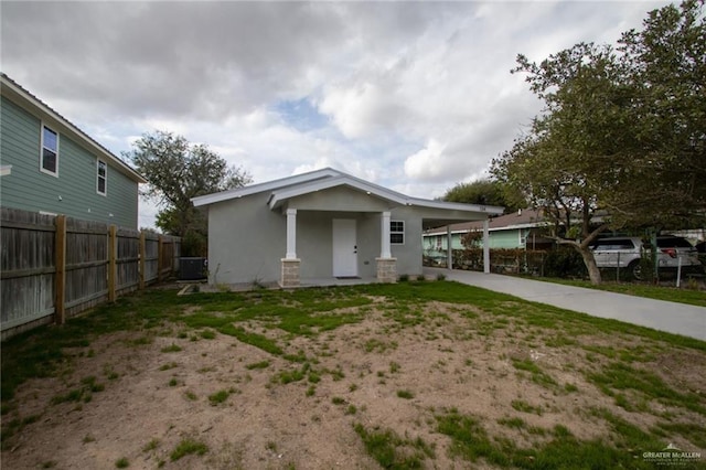 view of front of house with cooling unit and a carport