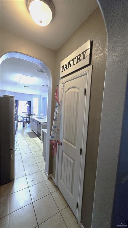 hallway featuring light tile patterned flooring