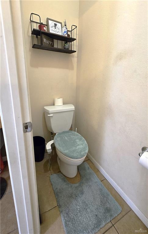 bathroom with tile patterned flooring and toilet