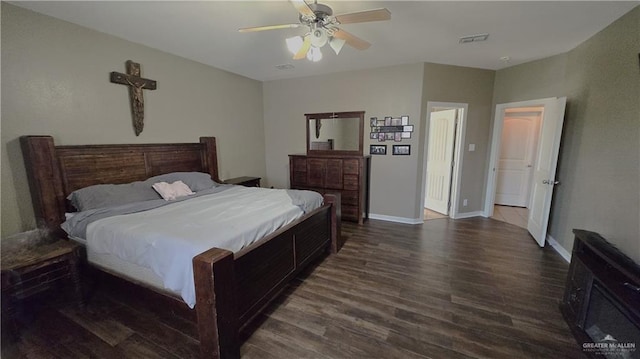 bedroom with dark hardwood / wood-style flooring and ceiling fan