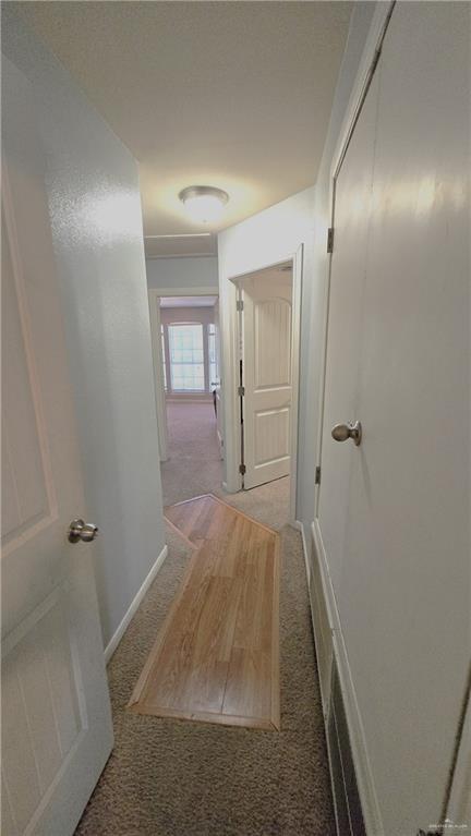 hallway with light colored carpet