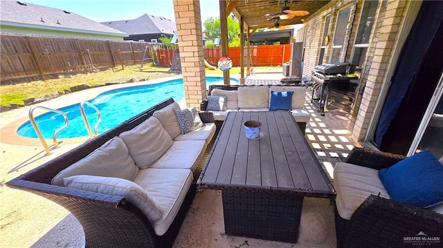 view of patio / terrace featuring ceiling fan, a grill, a fenced in pool, and an outdoor living space