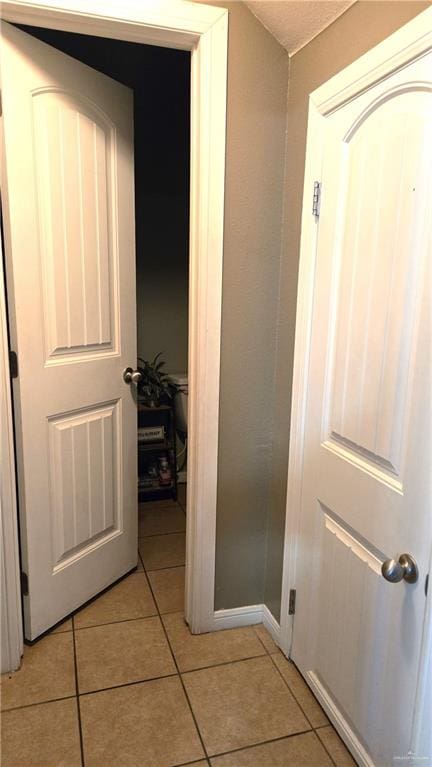 hallway featuring light tile patterned floors