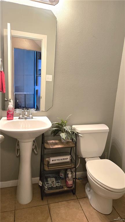 bathroom with tile patterned floors and toilet