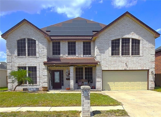 view of front facade featuring a front yard, solar panels, and a garage